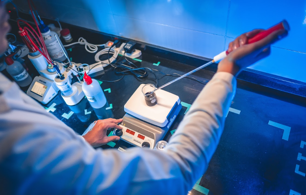 Laboratory technician conducting quality control testing for food concentrates at Al Fursan International for Food Industries